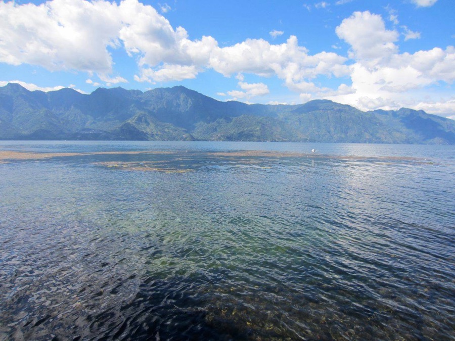 Mountains across Lake Atitlán on a sunny day