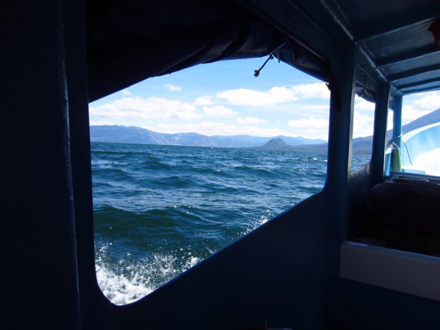 View of the lake and a volcano from inside a lancha, the local passenger boat